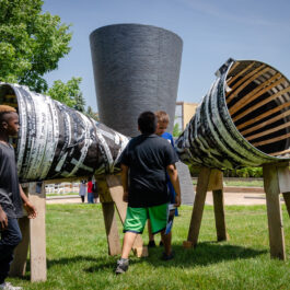 Photo of several local African-American middle school students examining sculptures in a local park